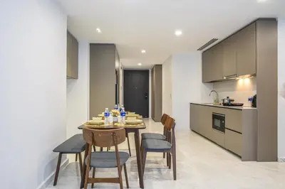 a kitchen and dining room with a table and chairs at Eaton KLCC Suites By Elite in Kuala Lumpur