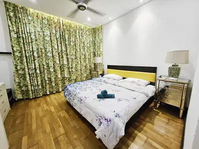 a bedroom with a bed with a yellow headboard at Blue Sky Apartment in Kuala Lumpur