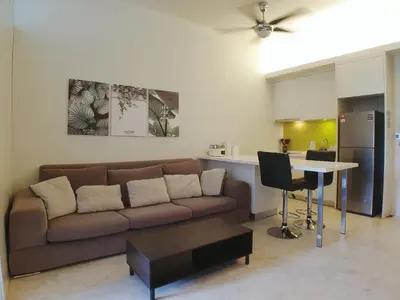 a living room with a couch and a table at The Signature & Hotel Suites Mont Kiara Kuala Lumpur in Kuala Lumpur