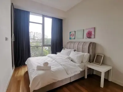 a bedroom with a large white bed with a window at The Signature & Hotel Suites Mont Kiara Kuala Lumpur in Kuala Lumpur