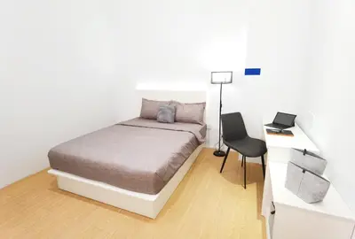 a bedroom with a bed and a desk and a chair at The Blueprint @ Bangsar South Mid Valley in Kuala Lumpur