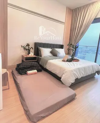 a bedroom with two beds and a large window at Continew Residences Kuala Lumpur in Kuala Lumpur