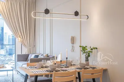 a dining room with a table and a couch at Continew Residences Kuala Lumpur in Kuala Lumpur