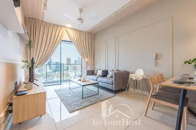a living room with a couch and a table at Continew Residences Kuala Lumpur in Kuala Lumpur