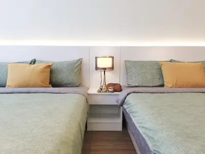 two beds sitting next to each other in a room at The Territory @ Bangsar South Mid Valley in Kuala Lumpur