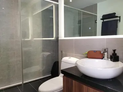 a bathroom with a sink and a toilet and a mirror at The Territory @ Bangsar South Mid Valley in Kuala Lumpur