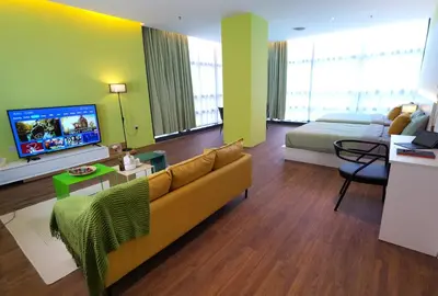 a living room with a couch and a bed and a tv at The Territory @ Bangsar South Mid Valley in Kuala Lumpur