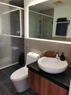a bathroom with a sink and a toilet and a mirror at The Territory @ Bangsar South Mid Valley in Kuala Lumpur