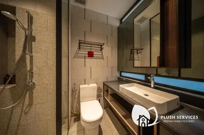 a bathroom with a toilet and a sink and a shower at Scarletz Suites KLCC in Kuala Lumpur