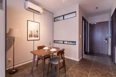 a dining room with a table and chairs at Scarletz Suites KLCC in Kuala Lumpur