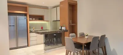 a kitchen with a dining table and a refrigerator at Anggun Platinum Suites in Kuala Lumpur
