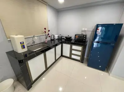 a small kitchen with a sink and a refrigerator at Dalamanda 3Pax Sunway Velocity Balcony CItyView in Kuala Lumpur