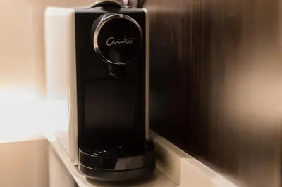 a black soap dispenser in a wall at Banyan Signatures Pavilion Kuala Lumpur in Kuala Lumpur