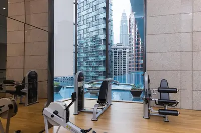 a gym with a view of a city skyline at Banyan Signatures Pavilion Kuala Lumpur in Kuala Lumpur