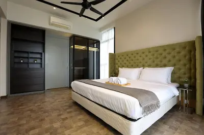 a bedroom with a large bed with a large headboard at ExpressionZ Suites KLCC by EC in Kuala Lumpur