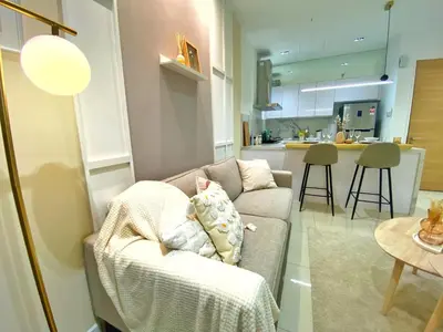 a living room with a couch and a kitchen at Lily and Loft - Camellia @ Bangsar Kuala Lumpur in Kuala Lumpur