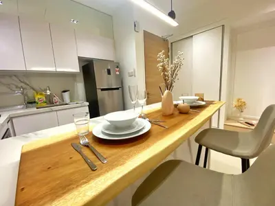 a kitchen with a table with plates and wine glasses at Lily and Loft - Camellia @ Bangsar Kuala Lumpur in Kuala Lumpur