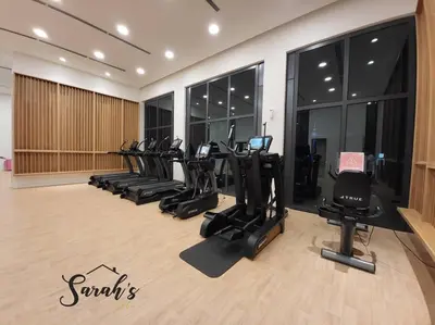 a gym with a row of treadms and elliptical machines at Lucentia Residence World Class Facilities Apartment Infinity Pool Stunning View in Kuala Lumpur