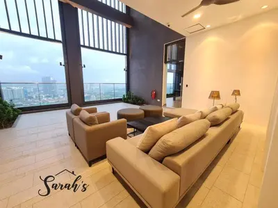 a large living room with couches and large windows at Lucentia Residence World Class Facilities Apartment Infinity Pool Stunning View in Kuala Lumpur
