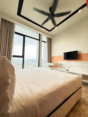 a bedroom with a large bed with a ceiling fan at Expressionz Professional Suites by AURORA SUMMER SUITES in Kuala Lumpur