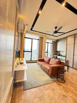 a living room with a couch and a table at Expressionz Professional Suites by AURORA SUMMER SUITES in Kuala Lumpur