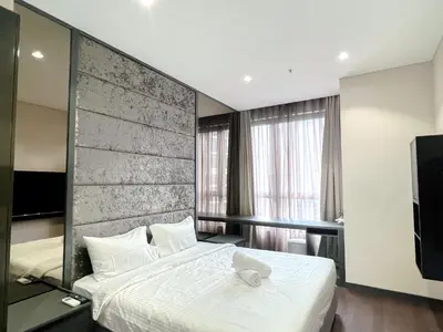 a bedroom with a large white bed and a television at 8 Kia Peng Residence Kuala Lumpur by Scape Stay in Kuala Lumpur