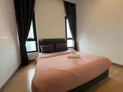 a bedroom with a large bed with two windows at Lucentia Residence BBCC Lalaport at Kuala Lumpur By Luxe Home in Kuala Lumpur