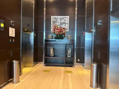 a lobby with a vase of flowers on a shelf at One Bukit Ceylon by Home Suites in Kuala Lumpur