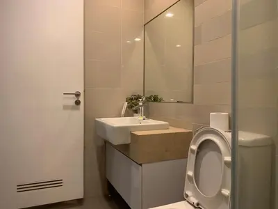 a bathroom with a sink and a toilet and a mirror at RS Suites In Bukit Bintang in Kuala Lumpur