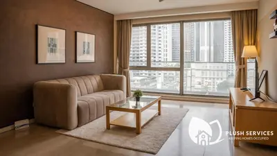 a living room with a couch and a table at Fairlane Residences by Plush in Kuala Lumpur