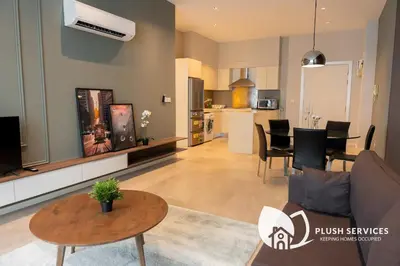 a living room with a couch and a table at Fairlane Residences by Plush in Kuala Lumpur
