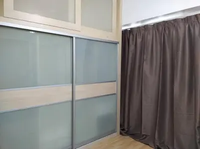 a room with glass sliding doors and a curtain at The Orion @Next to IJN 3 Bedroom Unit in Kuala Lumpur