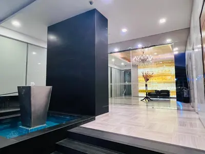 a lobby with a large black wall and a table at CozyHome Suites @ Casa Residency in Kuala Lumpur