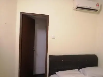 a bedroom with a bed and an open door at RAS International Hotel in Kuala Lumpur