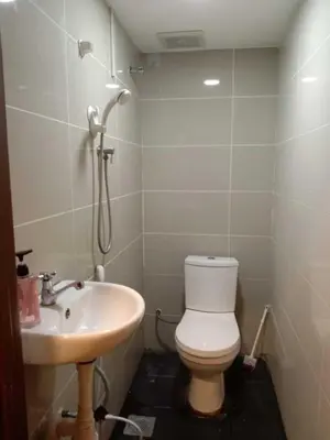 a bathroom with a toilet and a sink at RAS International Hotel in Kuala Lumpur