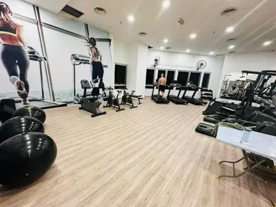 a gym with a woman doing a jump on a exercise ball at Taragon Homestay - Kuala Lumpur, Malaysia in Kuala Lumpur