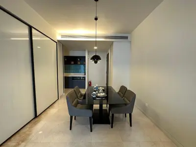 a dining room with a black table and chairs at Tropicana The Residence KLCC By Rainbow Suites in Kuala Lumpur