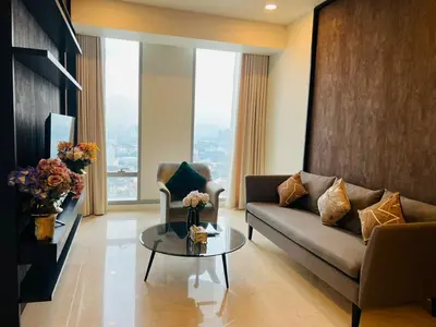 a living room with a couch and a glass table at Tropicana The Residence KLCC By Rainbow Suites in Kuala Lumpur
