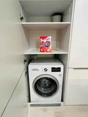 a laundry room with a washer and dryer at Tropicana The Residence KLCC By Rainbow Suites in Kuala Lumpur