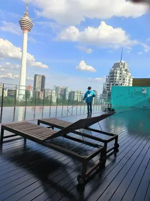 a person standing on a picnic table on a boardwalk at The RED in Kuala Lumpur