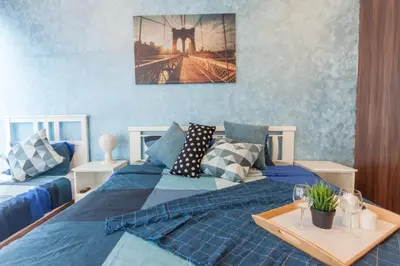 a bedroom with a blue bed with a tray on it at NaiBnB in Regalia Residence in Kuala Lumpur