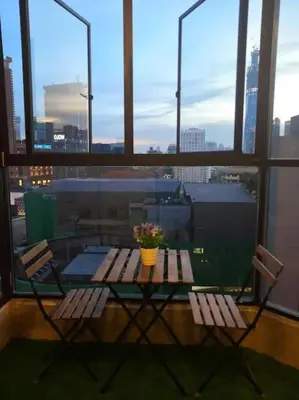 a table and chairs with a view of a city at Fahrenheit 88 Suites Bukit Bintang H 3R in Kuala Lumpur