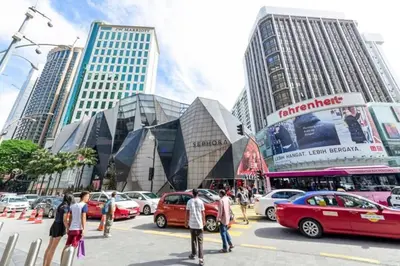 a busy city street with cars parked in front of tall buildings at Fahrenheit 88 Suites Bukit Bintang H 3R in Kuala Lumpur