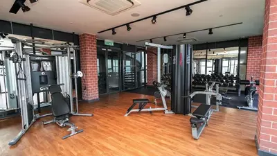 a gym with several treadmills and exercise bikes in it at Ceylonz Suites Bukit Bintang I HomeBrickz in Kuala Lumpur