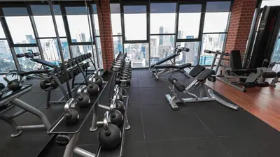a gym with rows of exercise bikes and treadmills at Ceylonz Suites Bukit Bintang I HomeBrickz in Kuala Lumpur