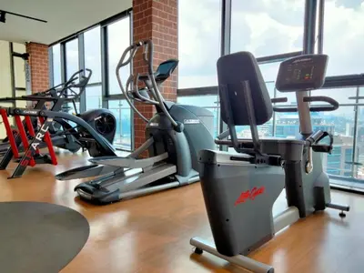 a gym with exercise bikes and tread machines at Ceylonz Suites Bukit Bintang I HomeBrickz in Kuala Lumpur