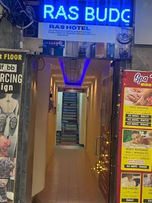 a hallway in a building with a staircase and a sign at RAS Hotel in Kuala Lumpur