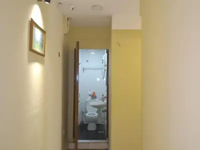 a bathroom with a toilet and a sink at RAS Hotel in Kuala Lumpur