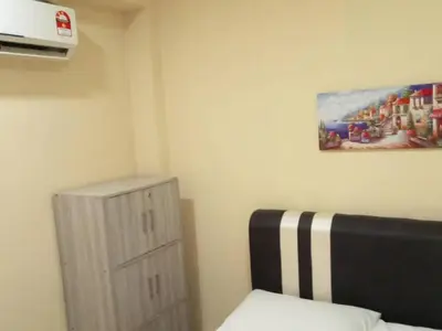 a bedroom with a bed and a painting on the wall at RAS Hotel in Kuala Lumpur