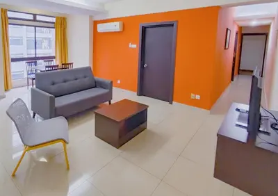 a living room with a couch and a tv at AJ-HOME Fahrenheit 88 Pavillion Bukit Bintang 8pax in Kuala Lumpur